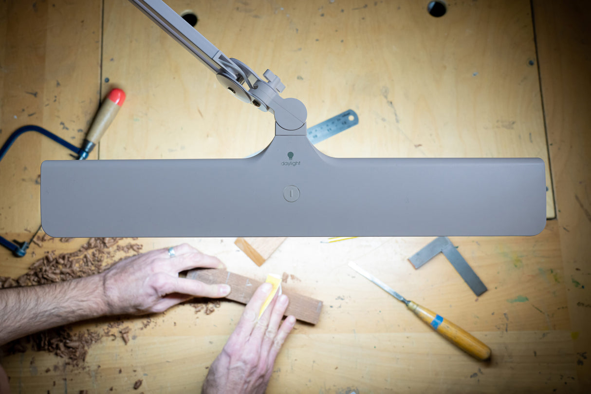 Daylight Lumi task lamp above workbench with tools