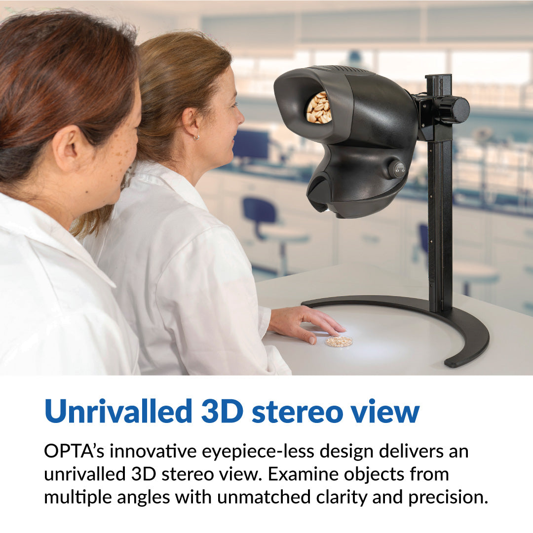 2 women in white lab coats looking at seed samples through the OPTA eyepiece-less stereo microscope